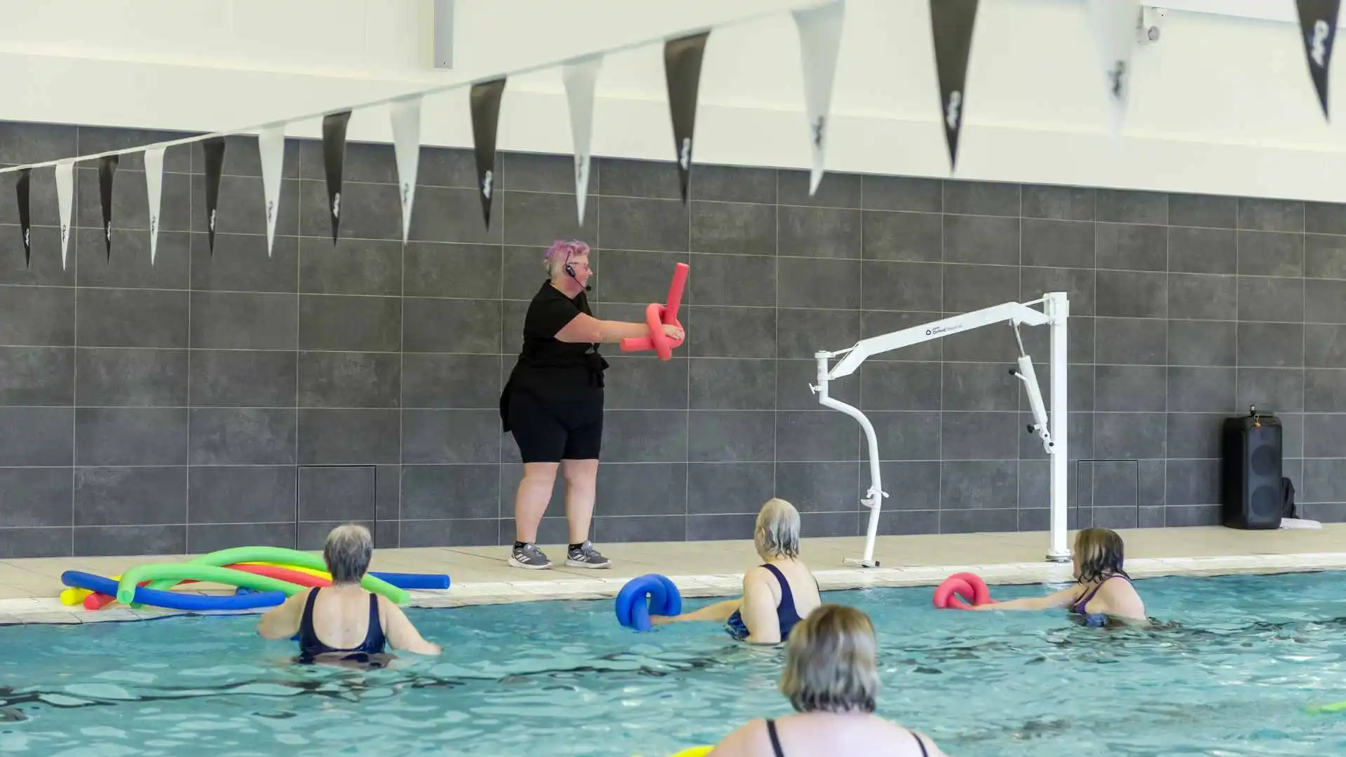 Ladies in a swimming pool doing a class