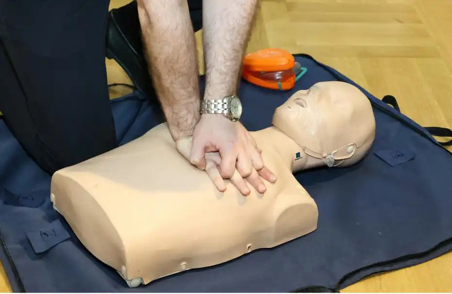 a person practices CPR on a dummy
