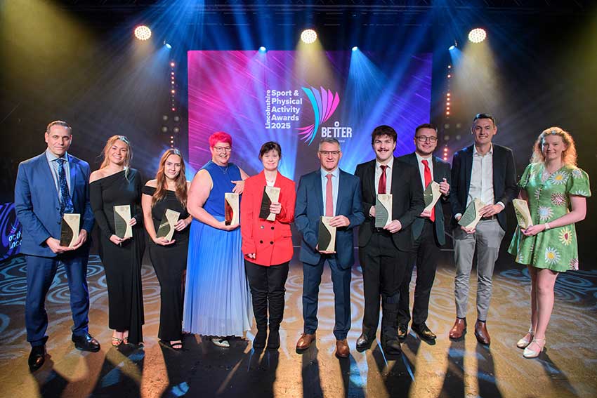Winners of the Lincolnshire Sport & Physical Activity Awards pose on stage holding their trophies